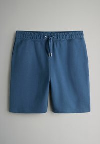 Blå ribstrikkede shorts med elastisk talje og snøre foran, vist fladt på en ensfarvet baggrund.