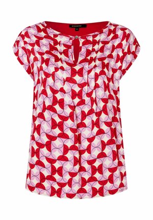 Kortærmet bluse med rødt, pink og hvidt geometrisk blomsterprint og lille midterste front med nøglehulsknaplukning.