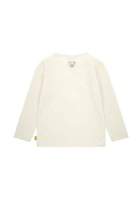 Long-sleeve cream shirt with a round neckline, featuring a small bear embroidery at the back and subtle puffed sleeves.