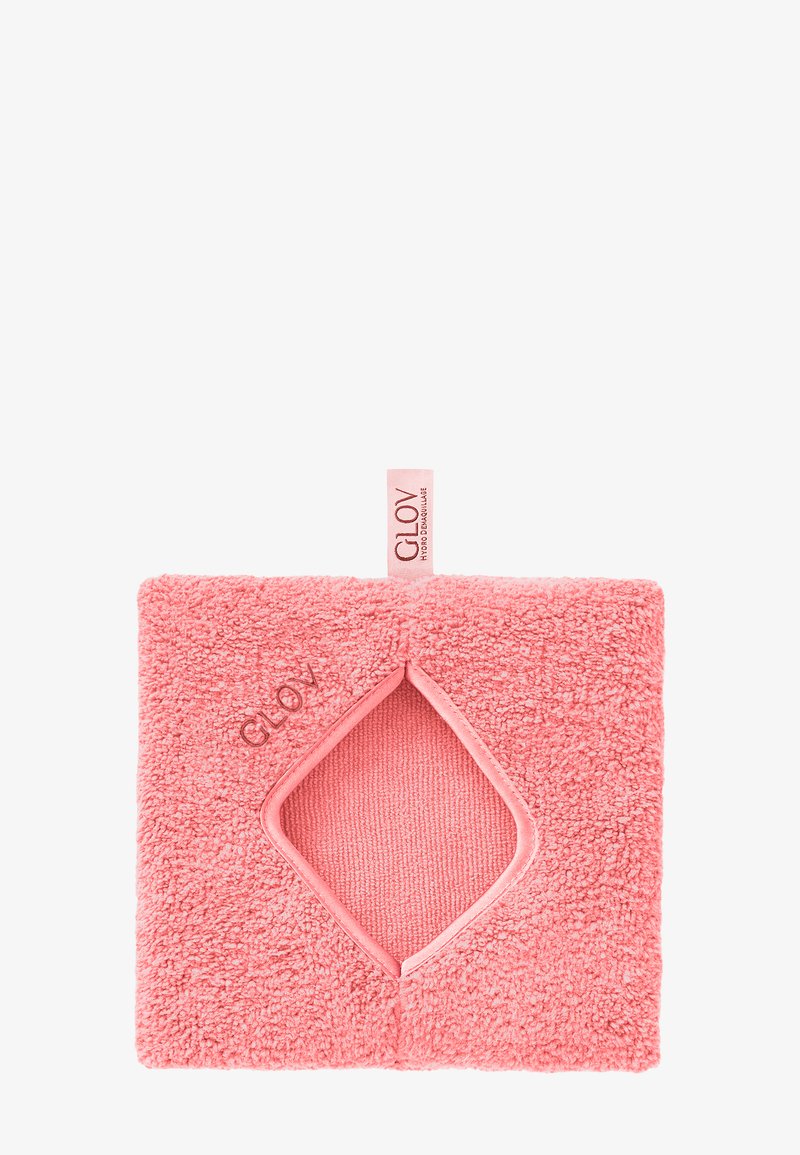 Tessuto rosa antico con texture e ritaglio a forma di diamante; marchio 'GLOV' in rilievo sulla superficie, completato da un piccolo etichetta in tessuto.