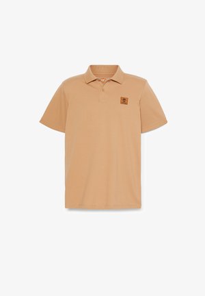 Khaki polo shirt with a collar, short sleeves, textured fabric, and a square Timberland logo patch on the left chest.