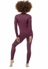 Burgundy thermal leggings and long-sleeve top with a geometric pattern on the back and side. Material appears soft and stretchy.