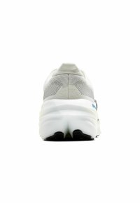 White athletic shoe with a textured mesh upper, padded collar, and a thick white sole. Features a black outsole for traction.
