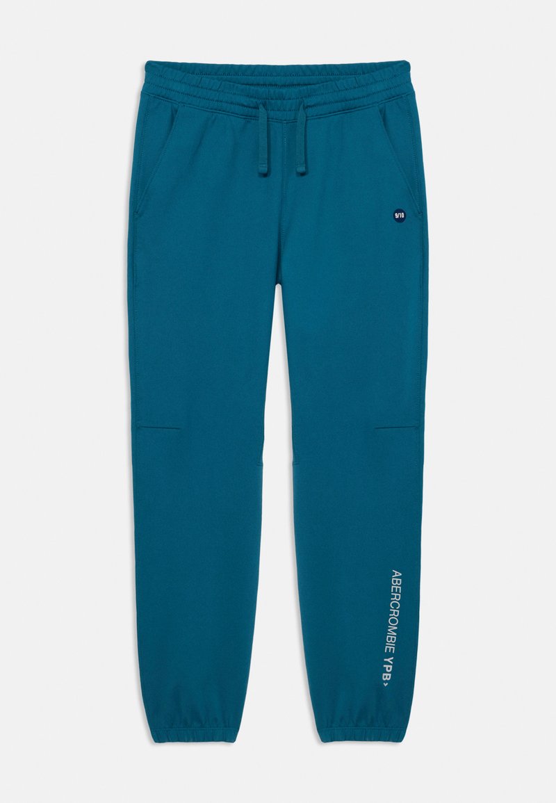 Teal sweatpants with an elastic waist, drawstring, side pockets, and cuffed hems. Features logo print on the left leg. Smooth texture.