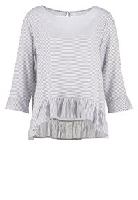Blouse femme manches longues à rayures gris clair et blanc, avec ourlet volanté et col rond avec fermeture par bouton dans le dos.