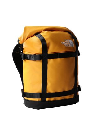 Yellow roll-top backpack with black straps and buckles, featuring The North Face logo on the front upper right side.