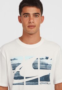 White cotton t-shirt featuring a blue graphic design of layered shapes and textures, with the brand name "O'Neill" printed at the bottom.