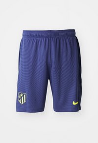 Paarse sportshorts van lichtgewicht stof, met een gestructureerd patroon, een Atlético Madrid-logo en een gele Nike-swoosh.