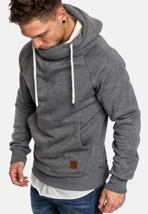 Gray hoodie with a large cowl neck, white drawstrings, front pocket, and a brown leather label at the bottom. Soft texture, casual fit.
