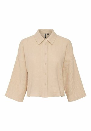 Beige, teksturoitu, nappilistapaita, jossa on leveät kolme neljäsosaa hihat ja terävä kaulus, esillä valkoista taustaa vasten.