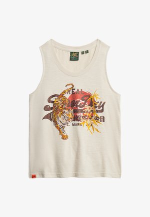 Débardeur couleur crème avec un graphique d'un tigre aux accents orange et du texte en rouge et noir. Fabriqué en tissu doux avec un col rond.