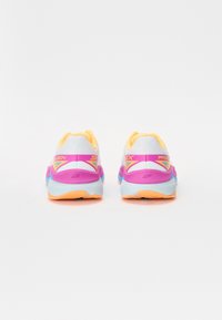 Skechers running shoes with a white mesh upper, pink and blue accents, yellow details, and textured soles for traction.