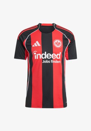 Κόκκινη και μαύρη ριγέ ποδοσφαιρική φανέλα με άσπρη λογότυπη χορηγίας "Indeed Jobs finden," λογότυπο Adidas και κυκλική σφραγίδα του συλλόγου στο στήθος.