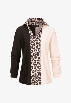 Nuppusideme, millel on kolm vertikaalset sektsiooni: ühtlane must, ühtlane helekreem ja leopardimuster. Pikad varrukad ja krae.