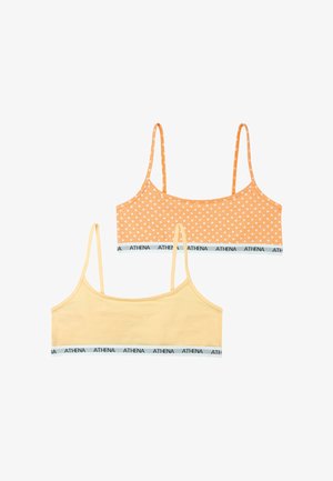Deux crop tops pour filles avec bretelles fines, un uni jaune pâle et un orange à pois blancs, tous deux avec le logo "ATHENA" sur la bande inférieure.