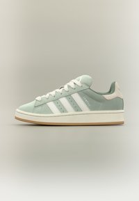 Light mint green suede sneaker with white stripes, rounded toe, rubber sole, and textured accents on the heel. Design features a classic style.