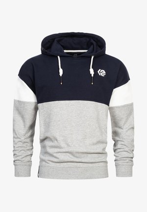 Huppari, jossa on tummansininen yläosa ja valkoinen ja harmaa väri-blokkaus. Varustettu nyöreillä, logolla sekä ribbausvarressa ja helmassa. Puuvillasekoitekangas.