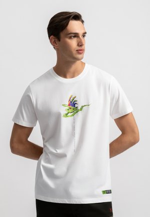 White short-sleeve t-shirt featuring a colorful graphic of a flower and hand design printed on the front; soft cotton fabric.