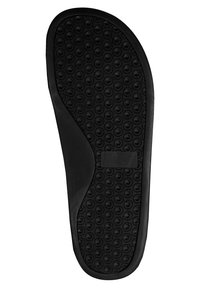 Zwarte rubberen schoenzool met een gestructureerd oppervlak met ronde patronen voor grip, gladde randen en een middensteunsectie.