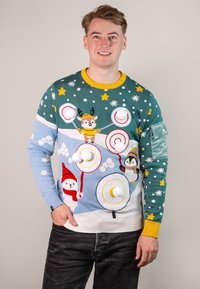 Knit sweater in green and light blue featuring snowmen, penguins, and a reindeer. Includes pom-poms and colorful star accents.