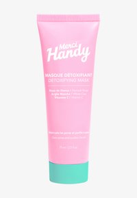 Rosa tub med en mintgrön botten, märkt "Merci Handy Detoxifying Mask." Innehåller ros, vit lera och vitamin C. 75 ml storlek.
