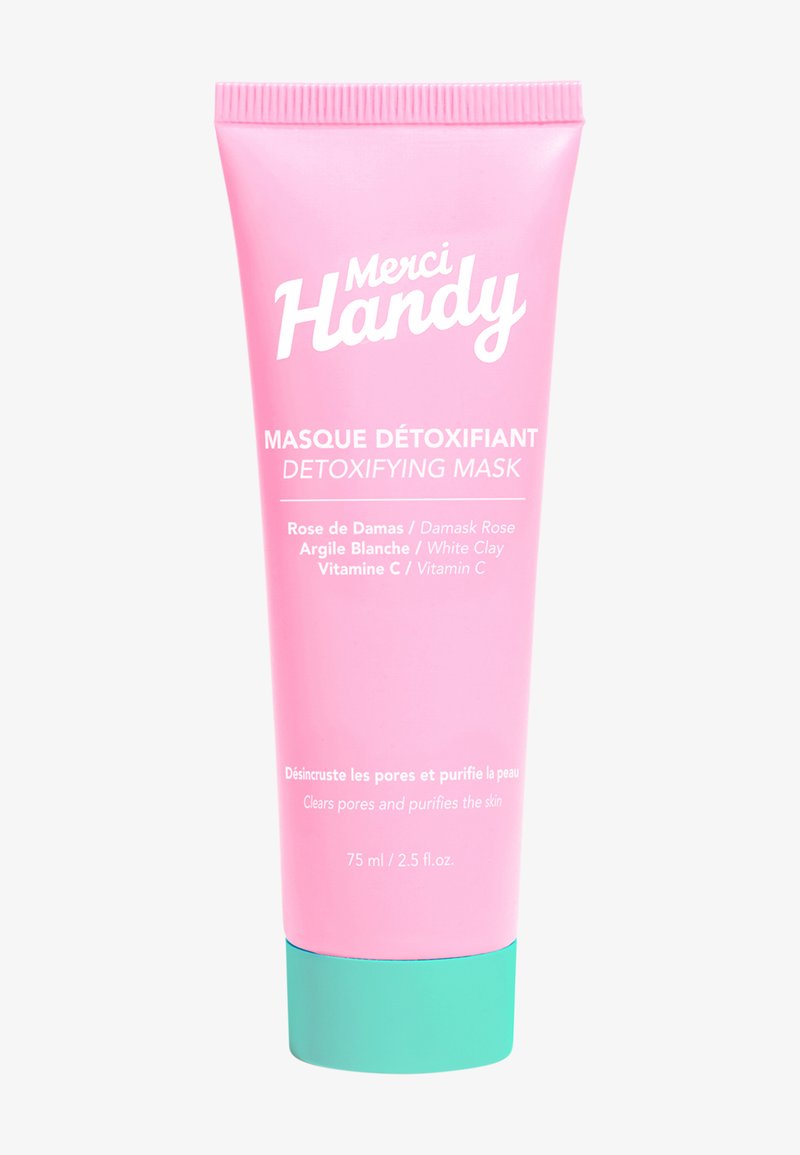 Rosa tub med en mintgrön botten, märkt "Merci Handy Detoxifying Mask." Innehåller ros, vit lera och vitamin C. 75 ml storlek.
