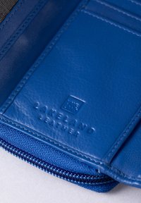 Blue leather wallet with embossed "Lakeland Leather" logo, featuring smooth texture, zip closure, and multiple card slots.