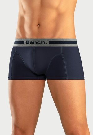 Navy cotton boxer briefs with a gray waistband featuring "Bench." logo, smooth texture, and contrast stitching details.