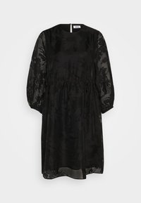 Robe noire avec manches longues en tissu transparent, encolure ronde et taille cintrée. Présente un motif subtil et une fermeture éclair au dos.