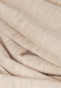 Tissu beige clair avec une texture douce, présentant un motif rayé subtil. Le matériau semble extensible et lisse, adapté à divers usages.