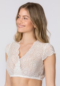 Weiße Spitzen-Bralette mit kurzen Ärmeln und V-Ausschnitt. Besitzt florale Muster und gewellte Kanten am Ausschnitt und Saum.