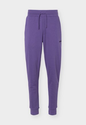 Pantaloni sportivi violeți conici, cu talie cu șnur și manșete la glezne, cu un mic logo negru pe coapsa superioară.