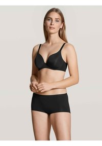 Reggiseno nero con coppe sagomate e spalline regolabili, abbinato a slip hipster neri coordinati. Tessuto liscio con un design senza cuciture.