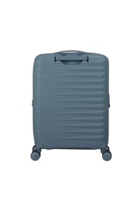Valigia espandibile in plastica texturizzata di colore blu scuro; presenta un manico superiore, quattro ruote e scanalature angolate per maggiore stabilità.