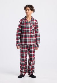 Red and green plaid pajamas with a button-up shirt featuring a chest pocket and long pants. Made of soft fabric, designed for comfort.