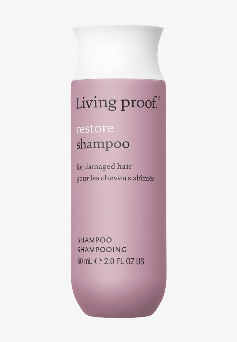 Flacon de shampooing Living Proof Restore pour cheveux abîmés, 60 ml, étiquette violet clair avec bouchon blanc et texte noir.