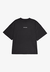 Black oversized short-sleeve t-shirt with white "PEGADOR" text centered on the chest, plain background.
