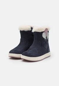 Bottines en suède navy avec doublure en fausse fourrure, design décoratif de ballon, fermeture éclair, et semelle en caoutchouc crème avec accents rose clair.