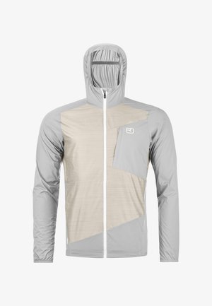Hellgraue und beige Kapuzenjacke mit durchgehendem Reißverschluss und Brusttasche, die auf der rechten Seite ein kleines weißes Logo trägt.