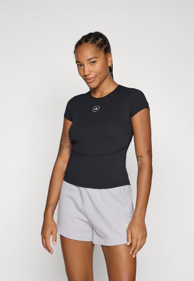 Black short-sleeve athletic shirt with a fitted design and a small white logo on the chest, paired with light gray shorts.