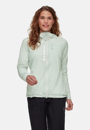 Light mint green outdoor jacket with a high collar, zippered front, and elastic hem. Features a logo on the chest and smooth, textured fabric.