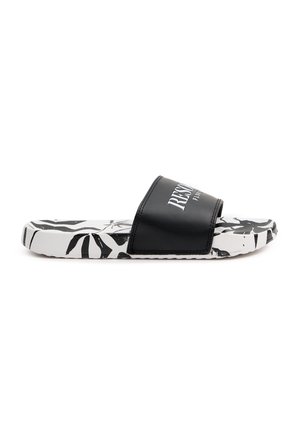 Chanclas negras con un upper texturizado y una suela blanca que presenta un patrón de hojas negras. El nombre de la marca se muestra en blanco.