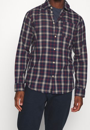Plaid shirt in navy, red, and white; long sleeves, button-up front, single chest pocket, cotton blend fabric, relaxed fit.