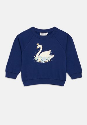 Navy blue long-sleeve sweatshirt with a white swan wearing a gold crown, surrounded by blue and yellow flowers on the front.