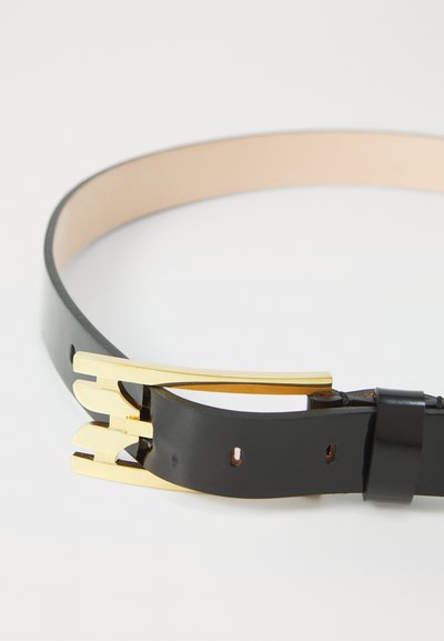 Μαύρη δερμάτινη ζώνη με λεία επιφάνεια, εμπλουτισμένη με ατσαλένιο κούμπωμα σε χρυσό τόνο και τρία ρυθμιζόμενα καρφάκια για ασφαλή κλείσιμο.
