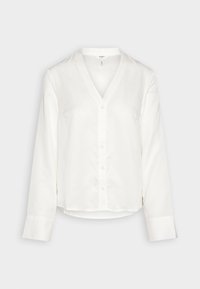 Camicia bianca a bottoni realizzata in tessuto morbido, con scollatura a V, maniche lunghe e orlo leggermente arrotondato. Design minimalista con bottoni discreti.