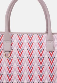 Lila och rosa chevron-mönstrad toteväska med grå syntetiska handtag, guldhardwaredetaljer och en slät, texturerad yta.