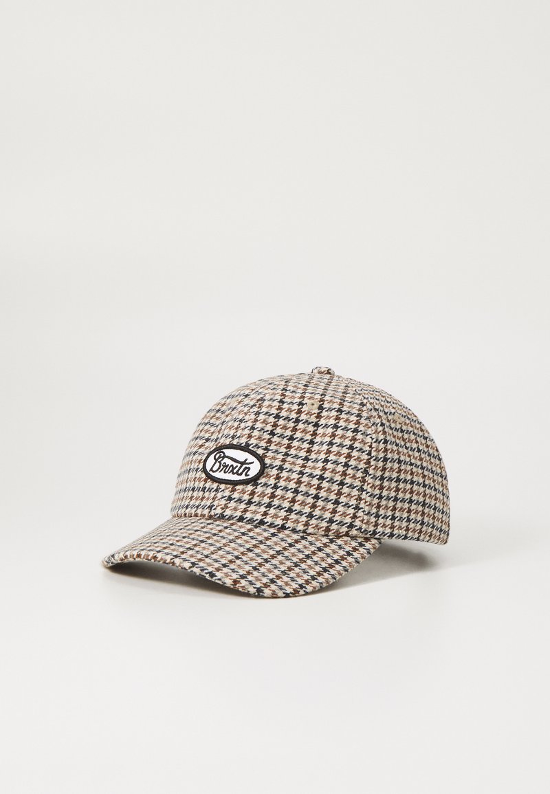Checkered cap made of fabric with brown, beige, and black tones. Features a curved brim and a stitched logo patch in black and white.