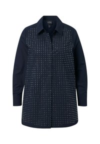 Navy blue shirt with long sleeves, a collar, and a buttoned front. Features a pattern of silver studs across the chest and back.