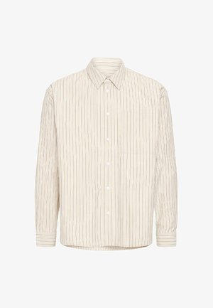 Světlé béžové košile na zapínání s vertikálními tmavě modrými pruhy, špičatým límečkem, dlouhými rukávy a jednou náprsní kapsou. Vyrobená z měkké látky.